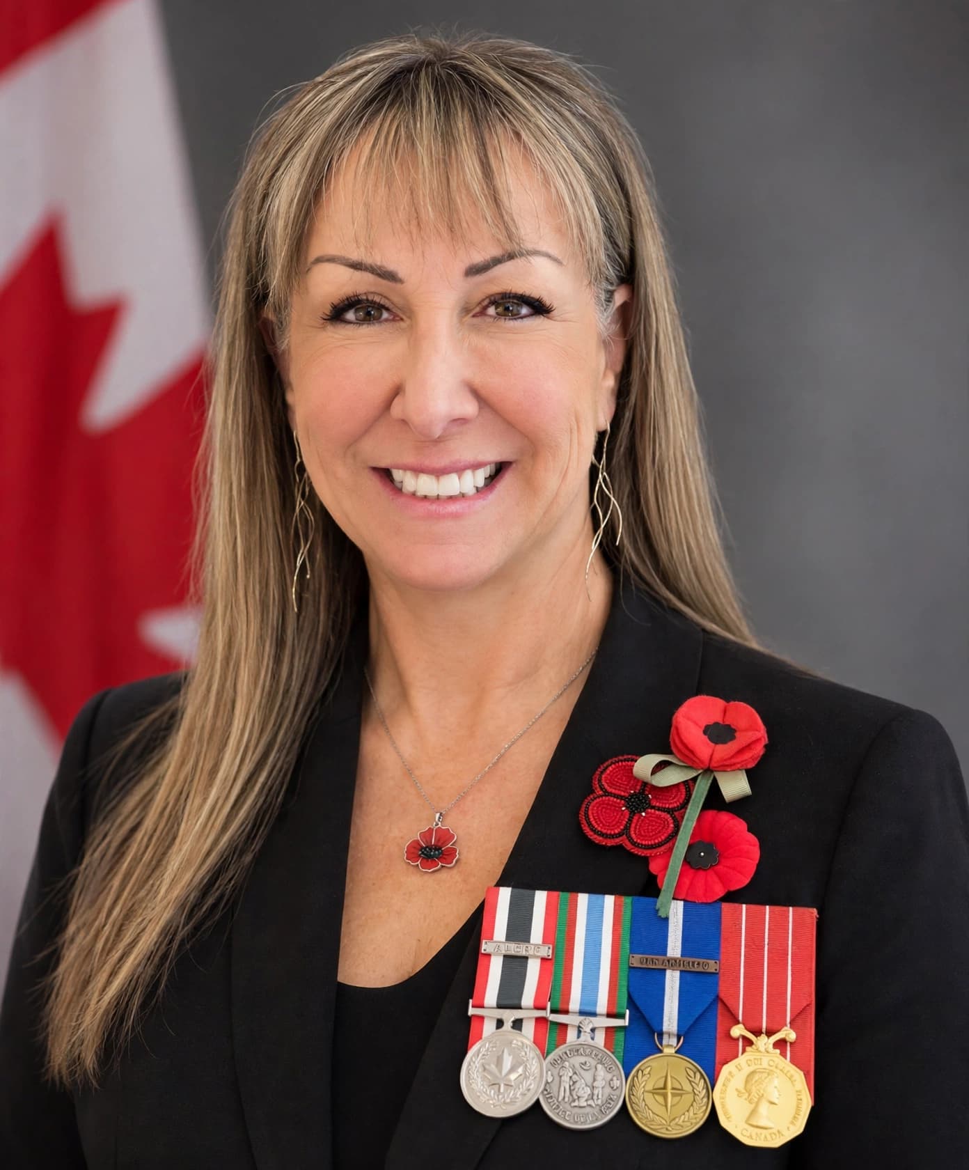 Mary Fielder wearing her service medals beside a Canadian flag